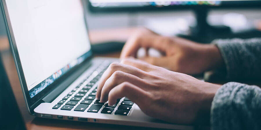 hands typing on keyboard