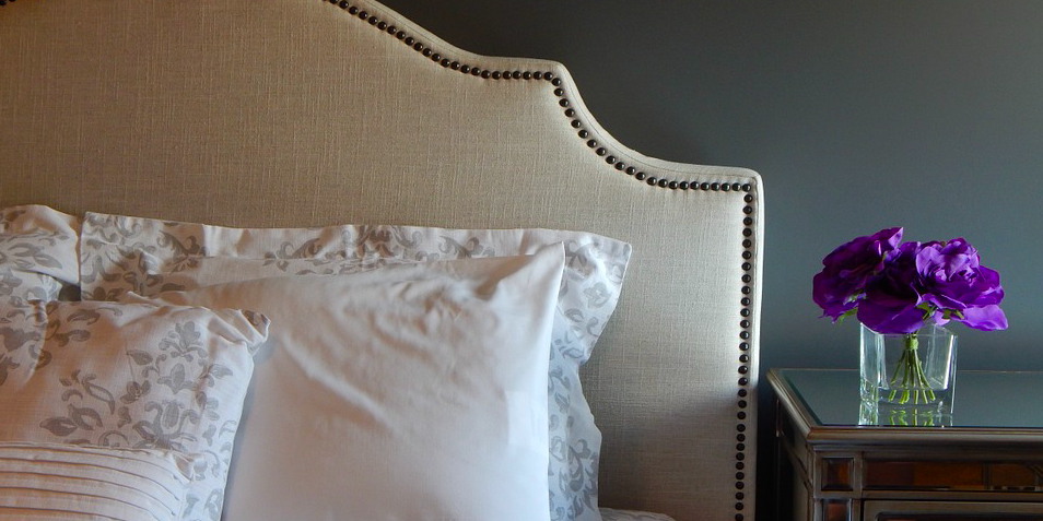 bed frame pillow and purple flowers