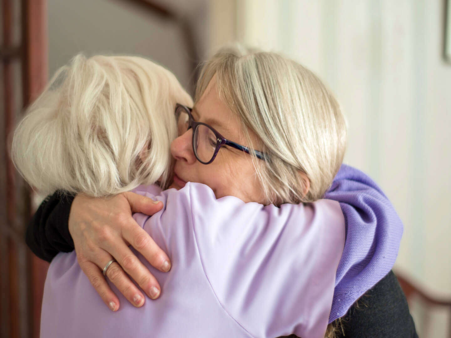 mature mother and daughter hugging