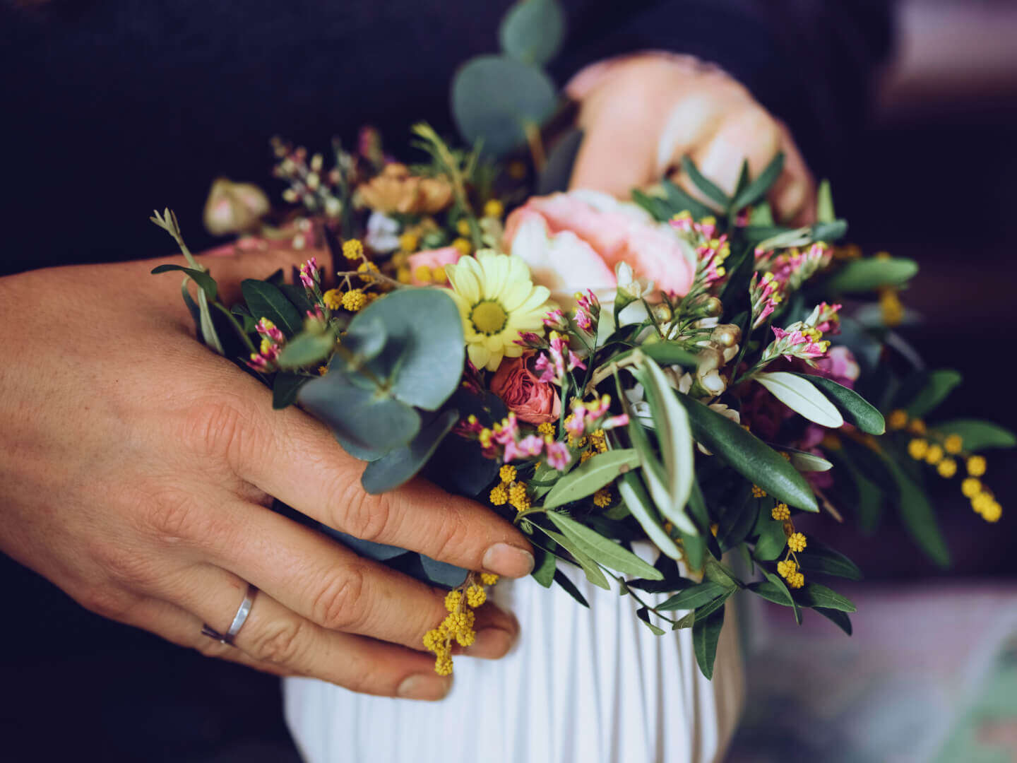 florist with fresh floral arrangement