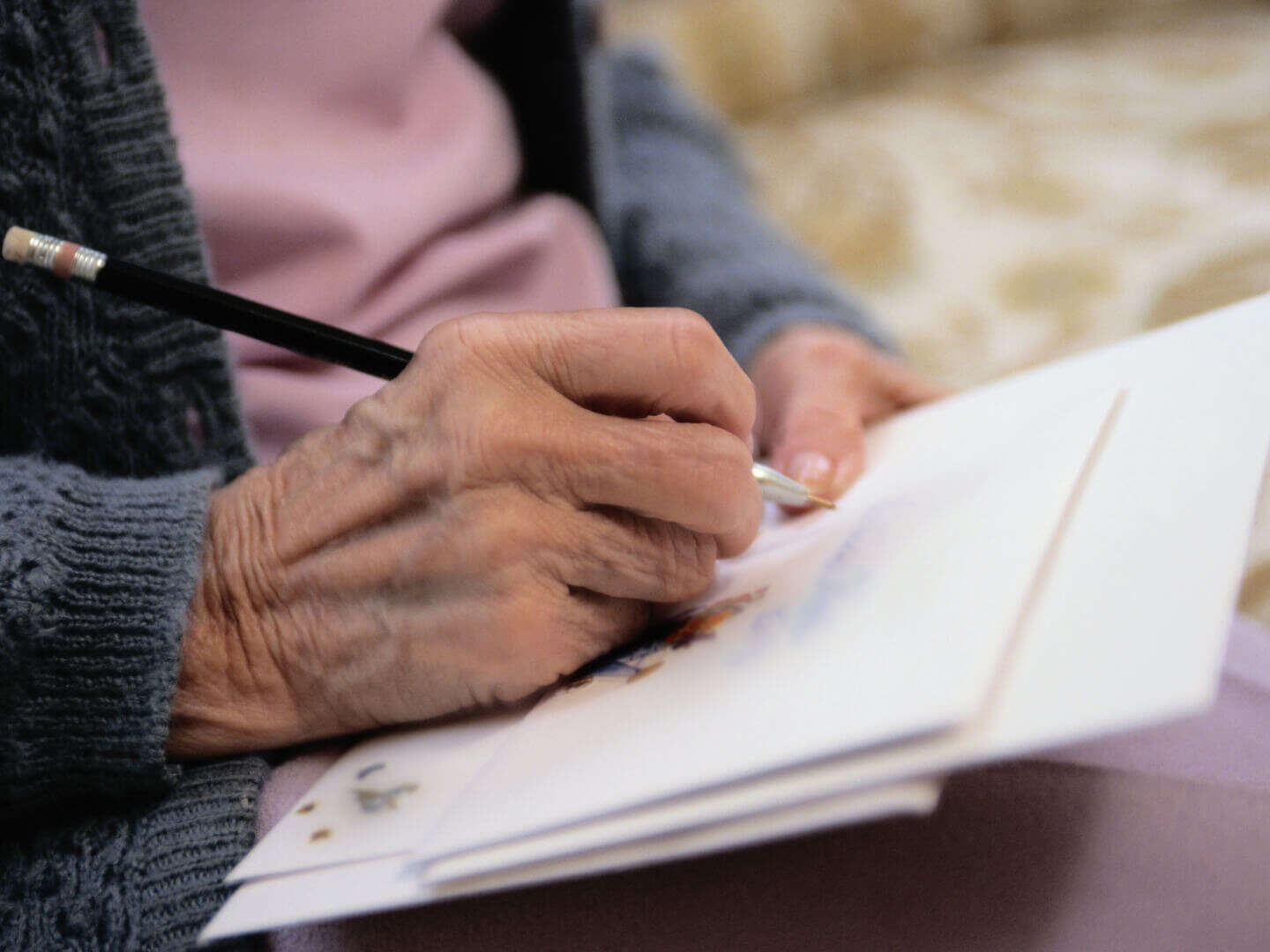 elderly woman hands writing card letter